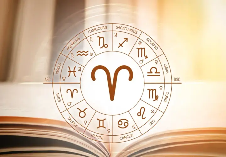 Koło zodiaku z symbolem Barana, uważanego za najbardziej agresywny znak zodiaku, na tle otwartej księgi.