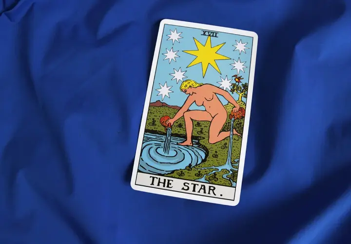 Karta Gwiazda Tarot symbolizuje nadzieję i spokój w uczuciach. Kobieta wylewa wodę, odnawiając życie.