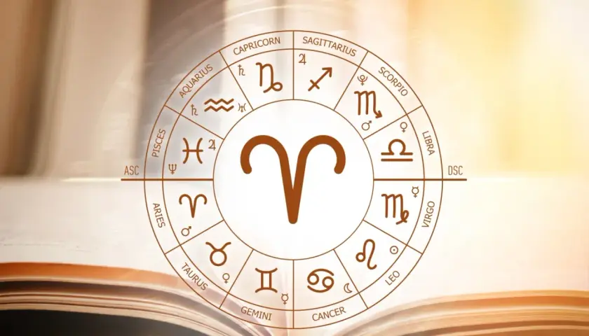 Koło zodiaku z symbolem Barana, uważanego za najbardziej agresywny znak zodiaku, na tle otwartej księgi.