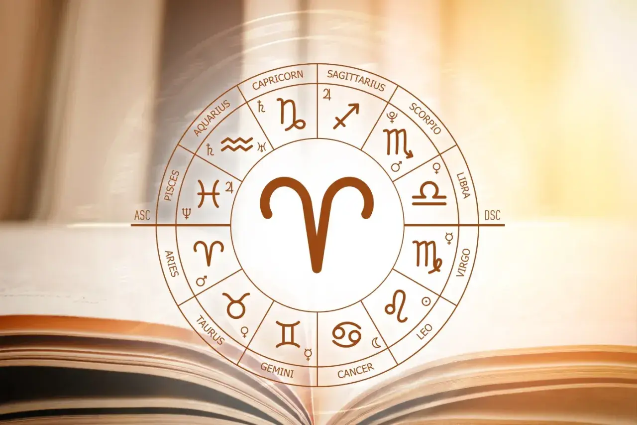 Koło zodiaku z symbolem Barana, uważanego za najbardziej agresywny znak zodiaku, na tle otwartej księgi.